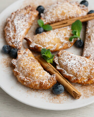 Sweet fried empanadas filled with fruit and blueberries.