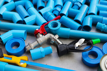 Plumber equipment with blue pvc pipe connections for plumbing work.