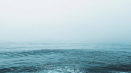Fototapeta premium Calm Ocean Waves Under a Misty Sky