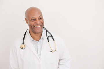 Fototapeta premium Smiling doctor in a white coat with a stethoscope
