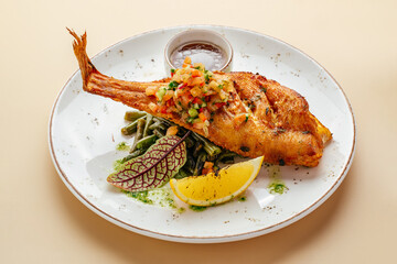 sea ​​bass with asparagus and sauce on a plate