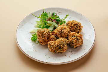 falafel on a plate with greens
