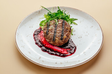 veal steak with sauce and arugula
