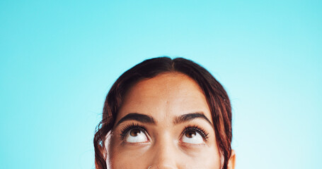 Closeup, eyes and woman in studio, thinking and problem solving on blue background. Person, looking...