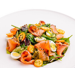 Fresh salad with smoked salmon, quail eggs, and cherry tomatoes