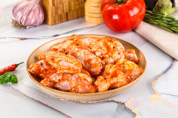 Raw marinated uncooked chicken wings