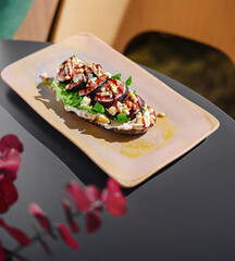 Delicious vegetarian open-faced sandwich on wooden table