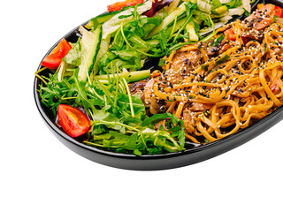 Delicious noodle dish served with fresh vegetables and salad
