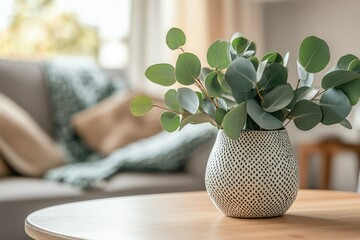 A soft-focus close-up of eucalyptus leaves in a minimalistic Scandinavian-style vase.