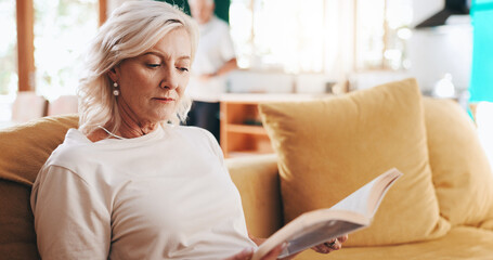 Old woman, book and reading to relax in home, learning new language and novel for entertainment. Hobby, peace and fiction to imagine story in living room, retirement and rest with fantasy information © KayExam/peopleimages.com