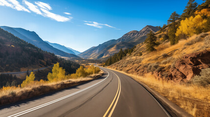 Fototapeta premium Scenic highway winding through mountains, showcasing vibrant fall colors, golden hour lighting, highlights the beauty of the landscape.