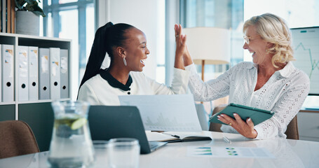 Fototapeta premium Business women, tablet and high five for success, teamwork and excited for achievement in office. Winning, manager and hands together with financial metrics, document and celebrate investment growth