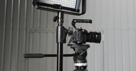 Digital Camera On A Tripod Behind Lighting Panel For Studio Shooting
