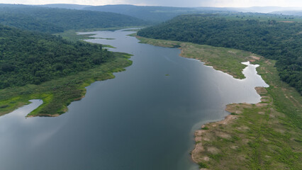 Drone shot. Aerial view scenic landscape of a large river delta amid a lush forest at the tropical...