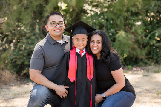 Proud parents celebrate their child's graduation milestone - Powered by Adobe