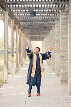 College graduate throwing cap in the air