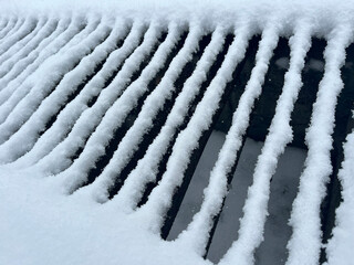 Snow-Covered Slatted Surface Creating Beautiful Frozen Geometric Patterns