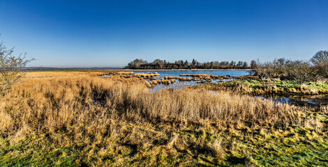 Obraz premium Idyllic Fjord Scene with Small Boat During a Sunny Day, Borre Knob, Denmark