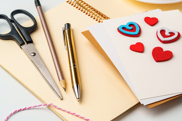 Creative workspace for making handmade greeting cards with colorful hearts and stationery