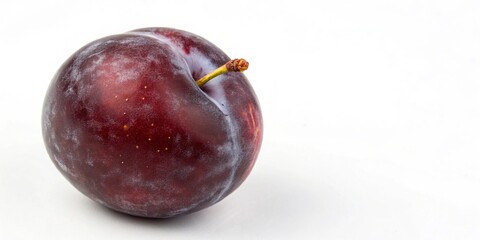 Obraz premium A single plum with a unique shape and rich color, ideal for culinary creations.