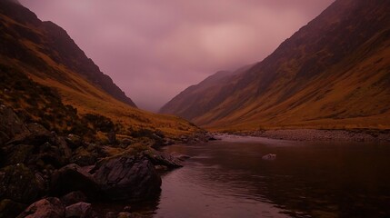 Fototapeta premium Moody valley landscape with river and fog-shrouded mountains