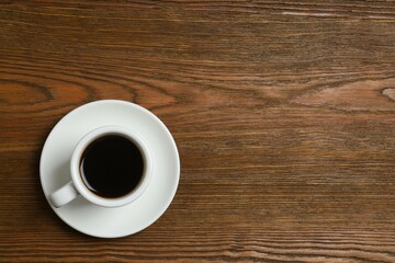 Cup of coffee on wooden background