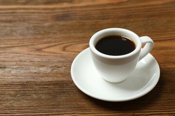 Cup of coffee on wooden background