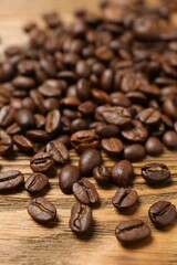 Fresh coffee beans on wooden background