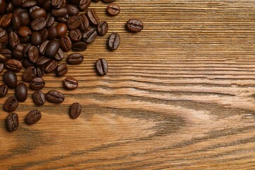 Fresh coffee beans on wooden background