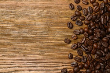 Fresh coffee beans on wooden background