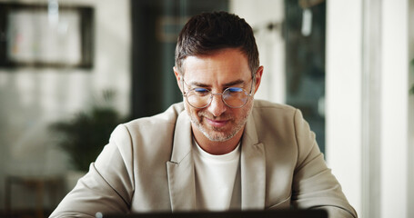 Finance, laptop and remote work with happy man in home office for investment or portfolio...