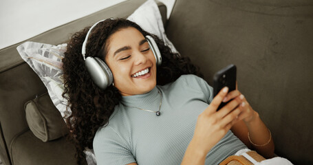 Cellphone, relax and woman with headphones on sofa listening to audiobook with mobile app for calm....