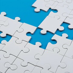 Abstract arrangement of white puzzle pieces on a blue background, illustrating problem-solving, teamwork and the concept of missing elements in a larger picture