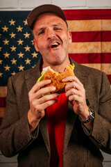 American man eating a hamburger.