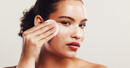 Portrait, cotton pad and woman with cosmetics, dermatology and clean on white studio background. Face, person and model with aesthetic, beauty and cleanser with skincare, wellness and remove makeup © peopleimages.com