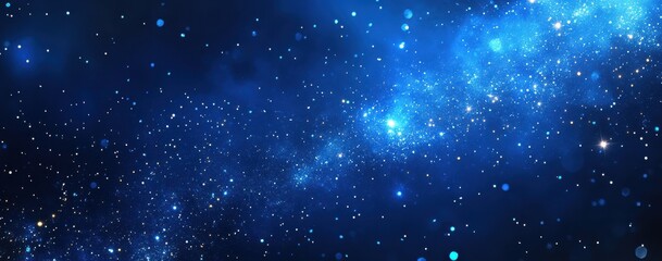 Fototapeta premium Vast cosmic expanse filled with stars and glowing nebulae in deep blue hues, perfect for illustrating the beauty of the universe and outer space exploration.