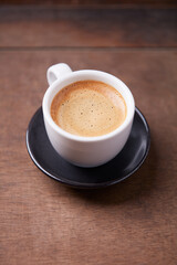 Cup of coffee on wooden background. Soft focus. Copy space