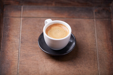 Cup of coffee on wooden background. Soft focus. Copy space