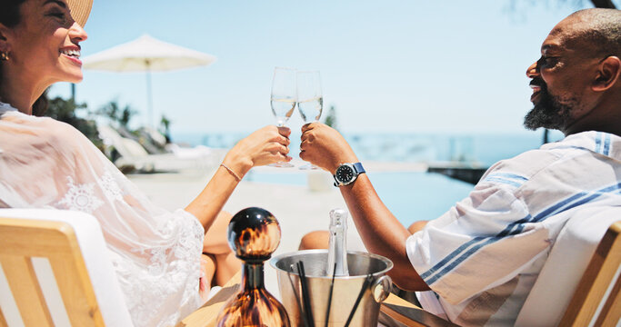 Couple, toast champagne and happy on patio, relax or view by ocean, celebration or cheers on valentines day. Mature people, man and woman for interracial love, drinks or holiday on balcony by sea
