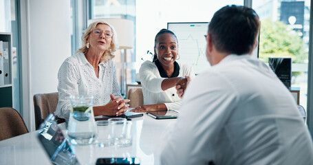 Fototapeta premium Business people, meeting and handshake with investor for agreement, financial deal and company funding. Happy group, partnership and shaking hands for support, merger or venture capital acquisition