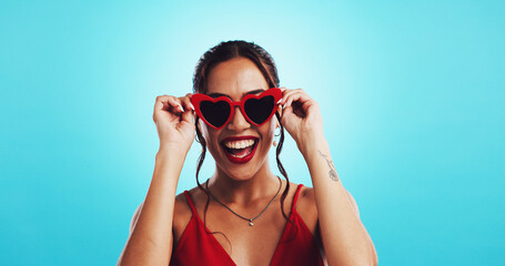 Fashion, laughing and woman with sunglasses, studio and excited for discount for product or mockup space. Blue background, trendy and person with sale for shades, Gen z and deal for happy customer