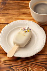 Delightful dessert on a plate beside a warm cup of coffee during a cozy morning break