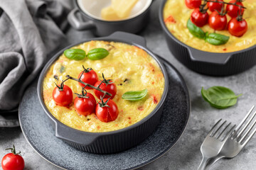 classic Greek pasta dish with a vegetable filling under a cheese crust on a gray background.