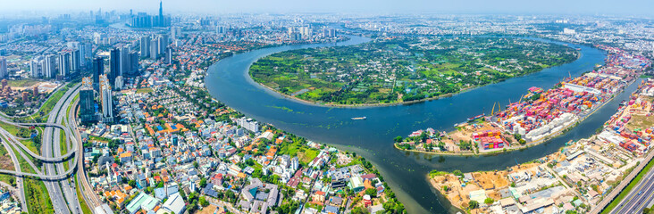 Top view aerial of a Ho Chi Minh City with development buildings, transportation, energy power infrastructure on a winter day. Cityscape on Saigon river in Ho Chi Minh City, Vietnam