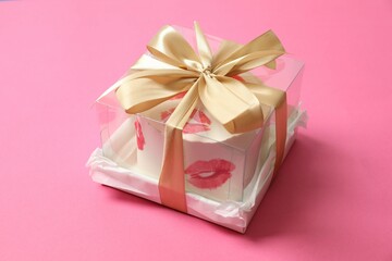 Colorful packaged cake decorated with red lips on a colored background