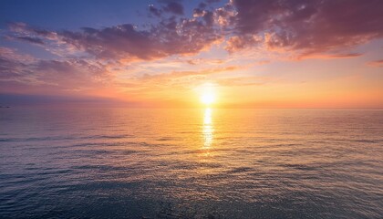 Fototapeta premium Sunrise sky with golden and pink hues spreading across a calm sea, perfect for morning-themed wellness and fitness promotions.