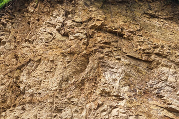 The texture of red mountain soil that is still wet on the mountain slopes