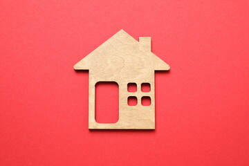 Wooden house on color background