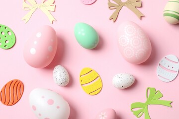 Happy Easter card. Easter eggs and decoration on color background, top view