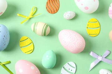 Happy Easter card. Easter eggs and decoration on color background, top view